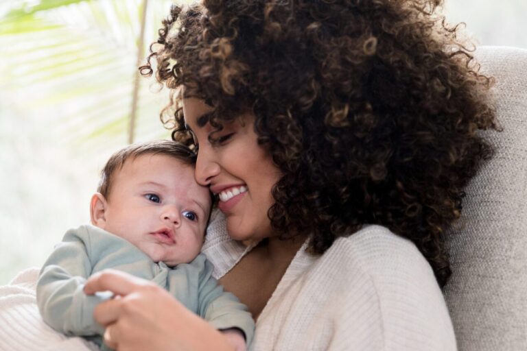 Parent and baby embracing.